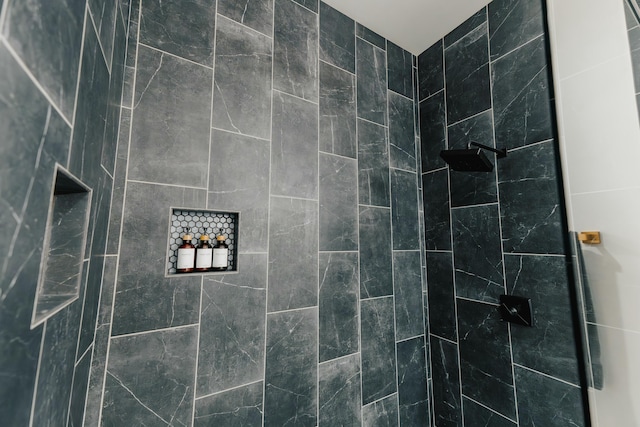 bathroom with a tile shower