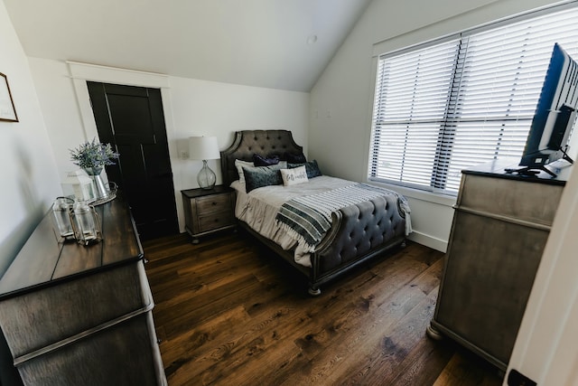 bedroom featuring dark hardwood / wood-style floors and lofted ceiling