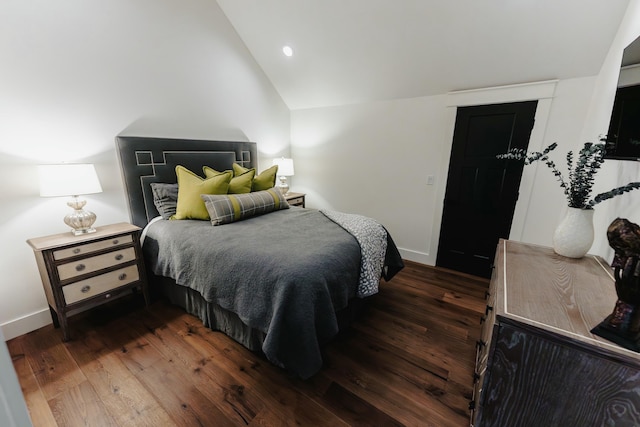 bedroom with dark hardwood / wood-style floors and vaulted ceiling