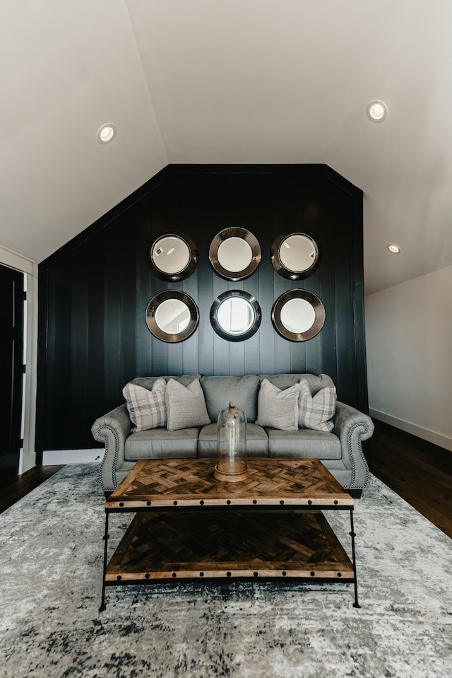 living room with dark wood-type flooring and vaulted ceiling