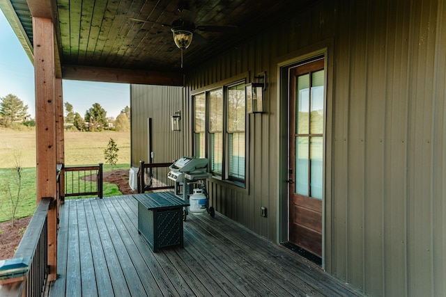 wooden terrace with area for grilling and ceiling fan