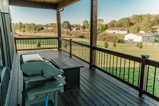 wooden terrace featuring a lawn