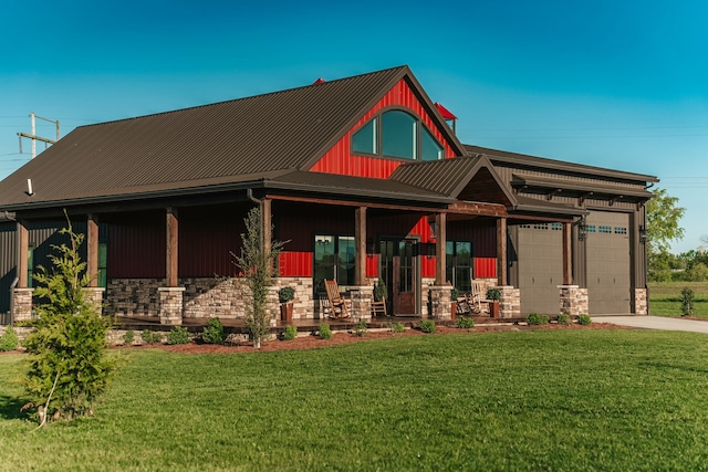 view of front of property with covered porch, a garage, and a front lawn