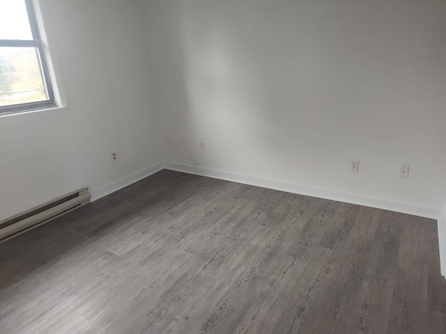 empty room with dark hardwood / wood-style flooring