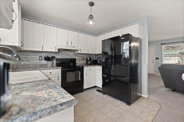 kitchen featuring white cabinetry, decorative backsplash, black appliances, and decorative light fixtures