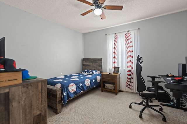 carpeted bedroom with ceiling fan and a textured ceiling