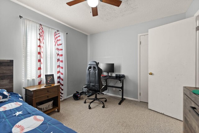 carpeted bedroom with ceiling fan and a textured ceiling