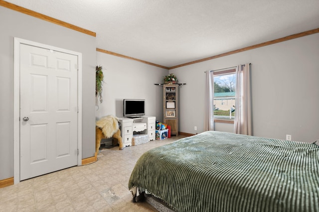 bedroom with a textured ceiling and crown molding