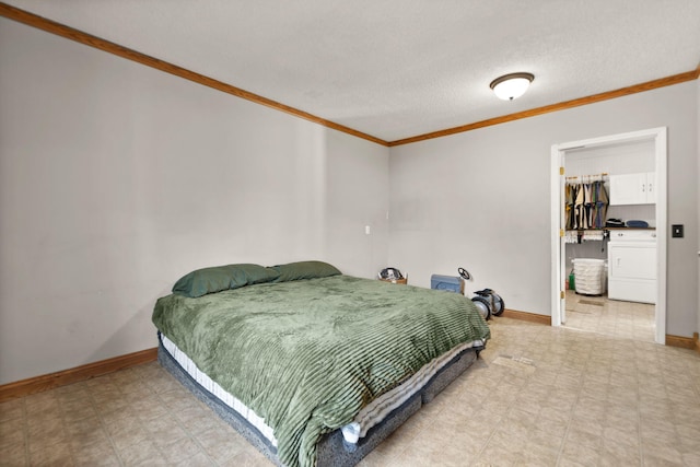 bedroom featuring a textured ceiling, washer / dryer, crown molding, a closet, and a walk in closet