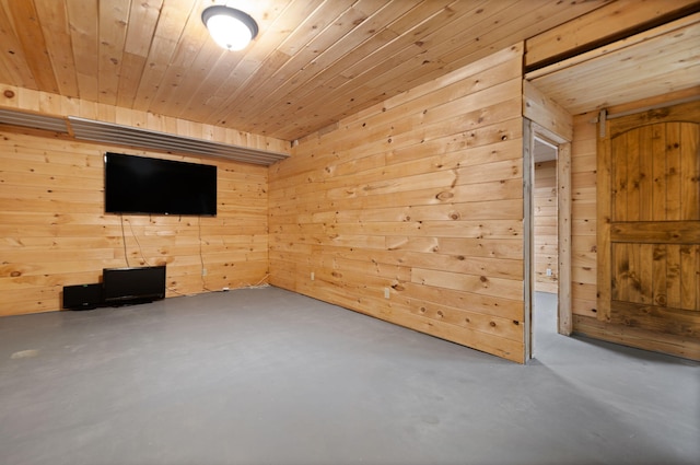 unfurnished living room with concrete floors, wooden walls, and wood ceiling