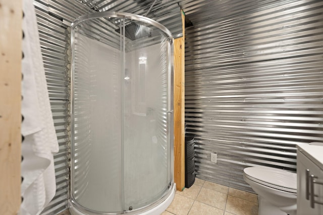 bathroom featuring vanity, a shower with door, and tile patterned flooring