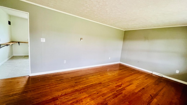 unfurnished room with wood-type flooring, a textured ceiling, and ornamental molding