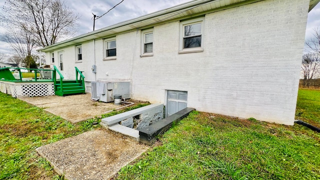 rear view of house featuring a yard and a deck