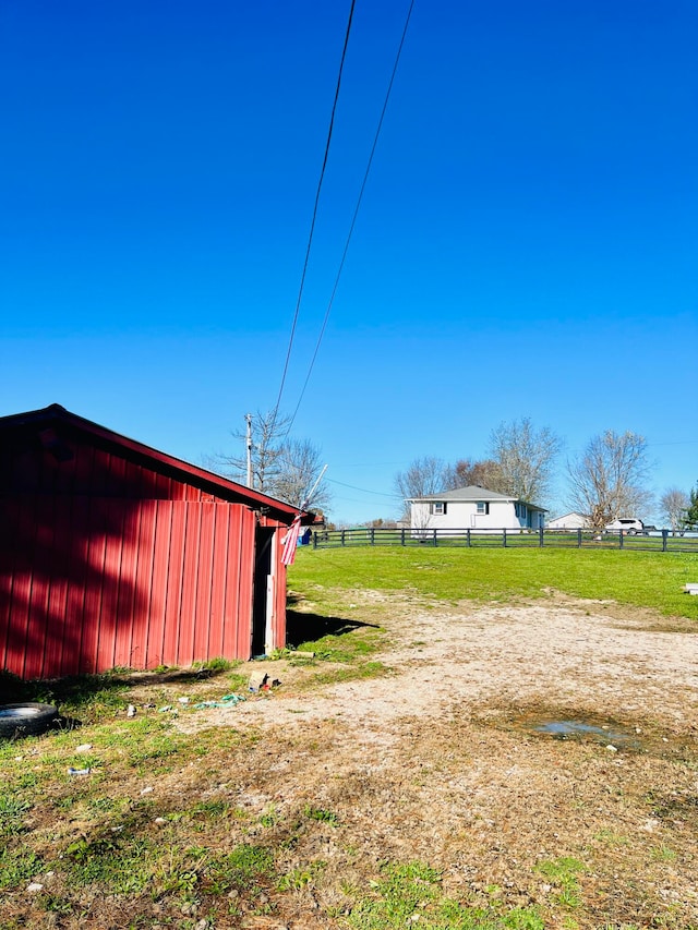 view of yard featuring an outdoor structure and a rural view