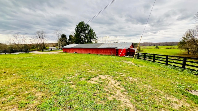 view of yard featuring an outdoor structure and a rural view