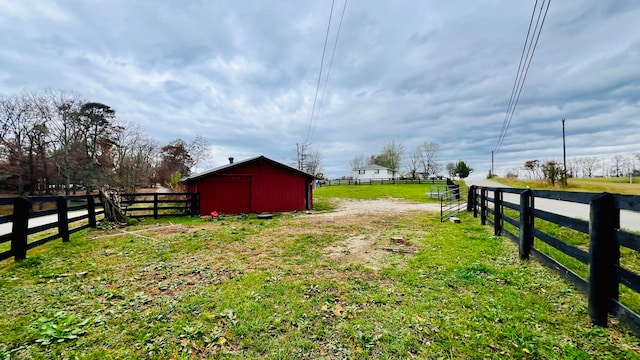 view of yard with a rural view and an outdoor structure