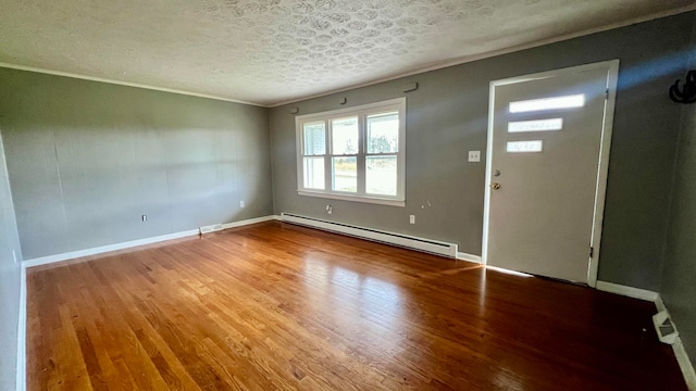 entryway with a textured ceiling, hardwood / wood-style floors, crown molding, and a baseboard radiator