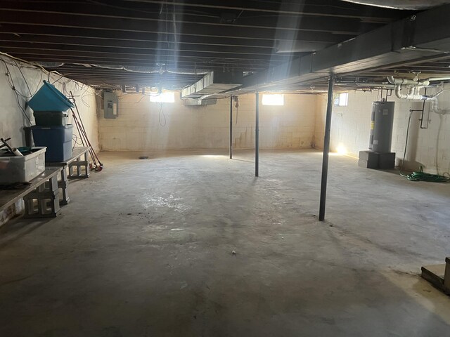 basement with electric panel and water heater