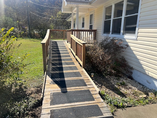 view of side of home featuring a lawn and a deck