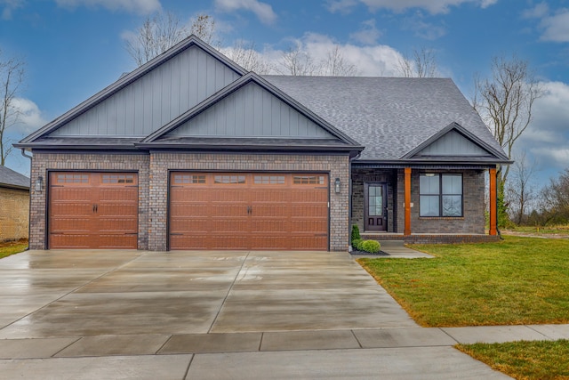 view of front of home with a front yard and a garage