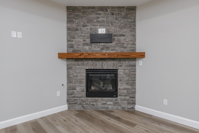 interior details with hardwood / wood-style floors and a fireplace