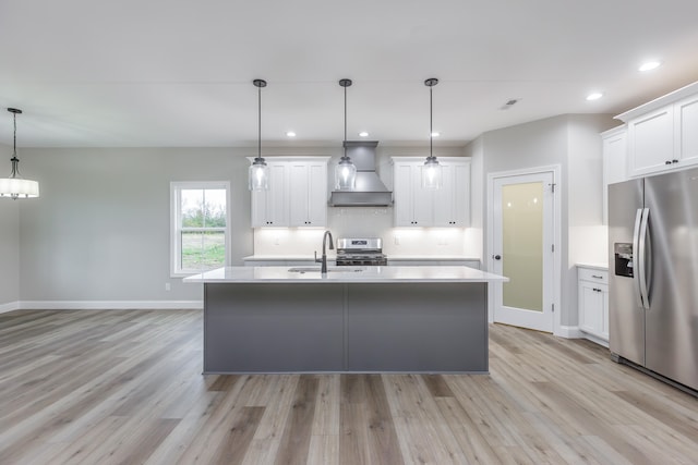 kitchen with custom exhaust hood, white cabinetry, stainless steel appliances, and hanging light fixtures