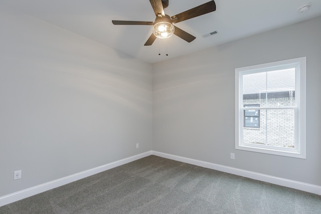 carpeted spare room with ceiling fan