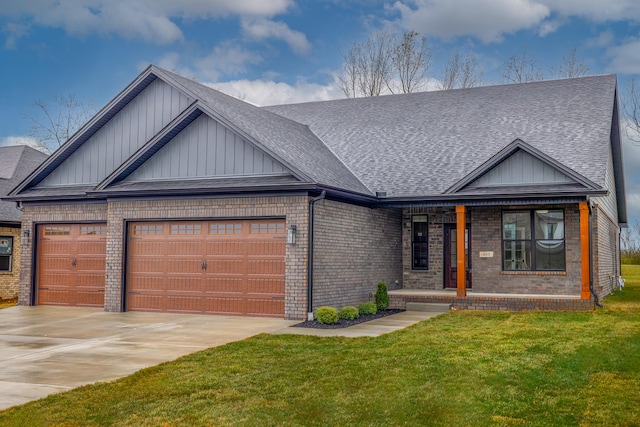 view of front of house featuring covered porch, a garage, and a front lawn