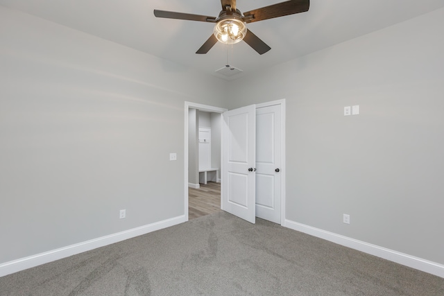 unfurnished room featuring light carpet and ceiling fan