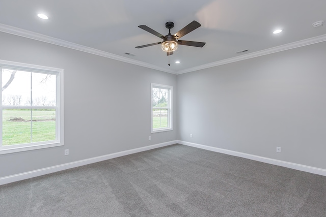 empty room featuring carpet floors, ceiling fan, and crown molding