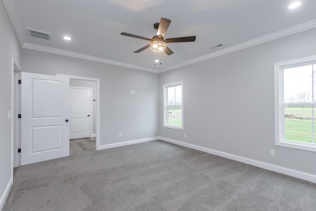 unfurnished room with crown molding, ceiling fan, a healthy amount of sunlight, and light carpet