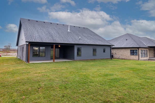 rear view of house with a lawn and a patio