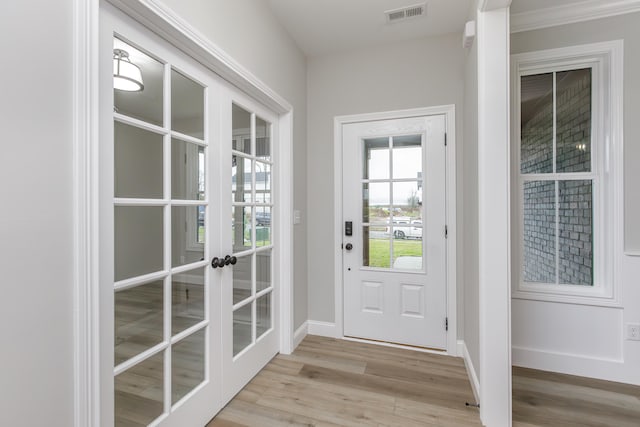 doorway featuring light wood-type flooring and french doors