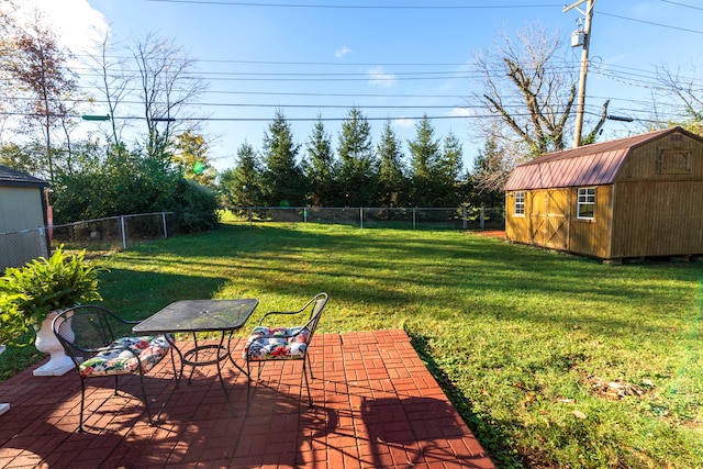 view of yard featuring a storage unit and a patio area