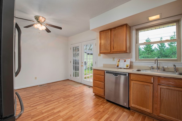 kitchen with french doors, appliances with stainless steel finishes, sink, ceiling fan, and light hardwood / wood-style flooring