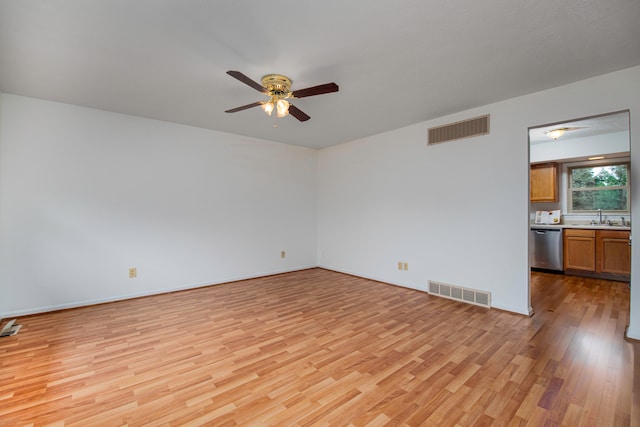 interior space with light hardwood / wood-style flooring, sink, and ceiling fan