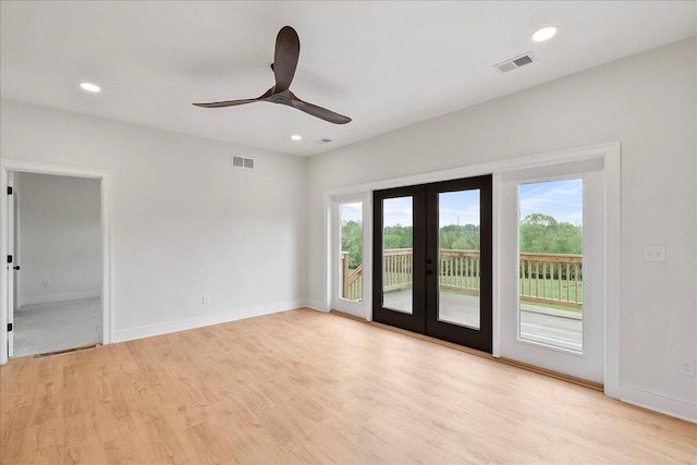 unfurnished room featuring visible vents, french doors, light wood-style flooring, and ceiling fan