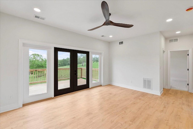 spare room with french doors, visible vents, and wood finished floors