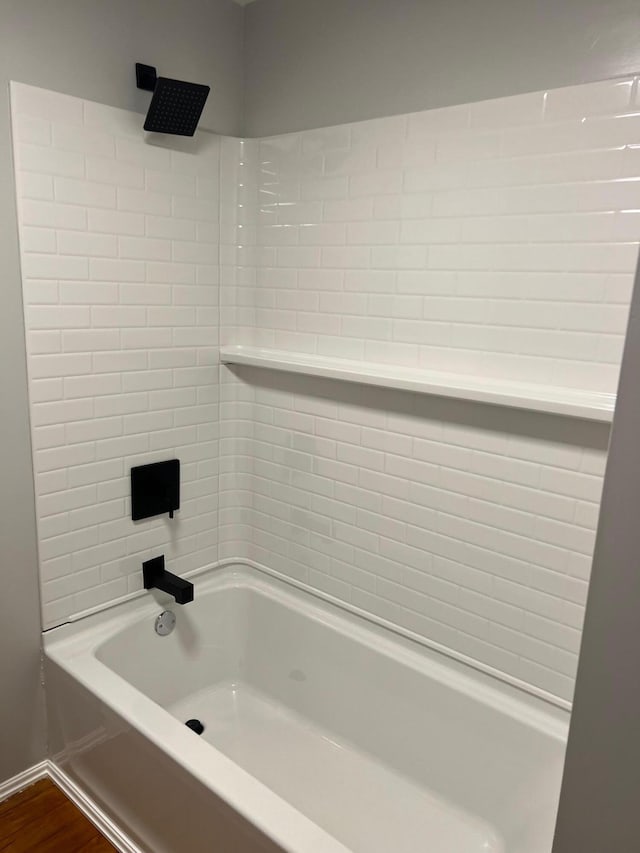 bathroom featuring shower / bathing tub combination and hardwood / wood-style floors