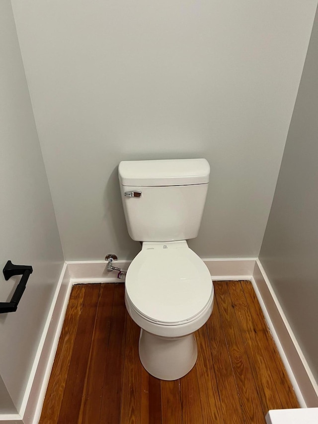 bathroom featuring wood-type flooring and toilet