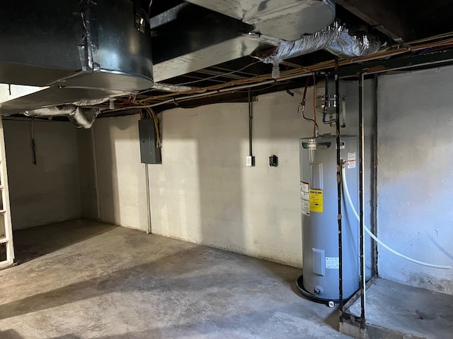 basement featuring electric panel and water heater