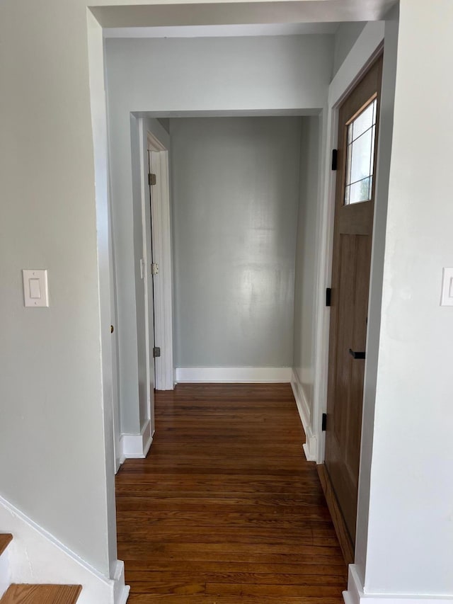 corridor with dark hardwood / wood-style flooring