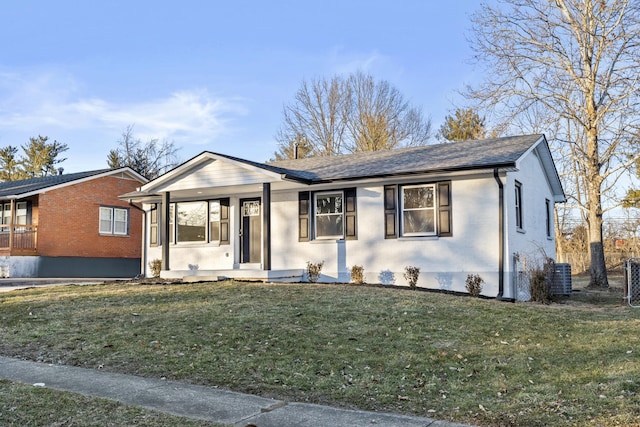 ranch-style house featuring central AC, covered porch, and a front lawn