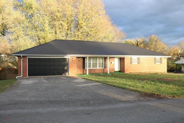 ranch-style home with a front yard and a garage