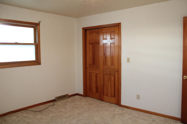 empty room featuring light colored carpet