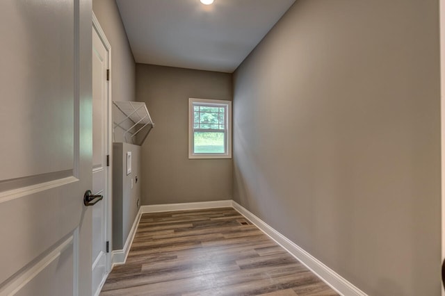 clothes washing area featuring hardwood / wood-style floors