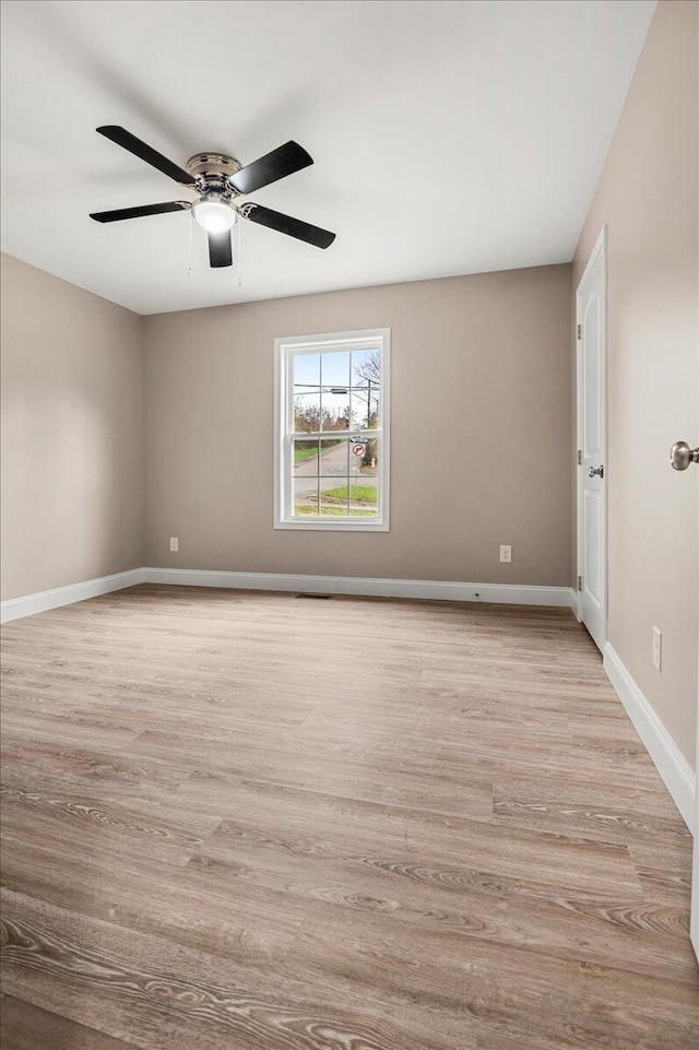 unfurnished room featuring ceiling fan and light wood-type flooring