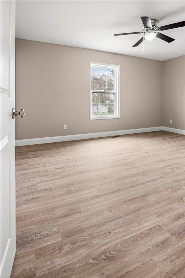 unfurnished room featuring ceiling fan and light hardwood / wood-style floors