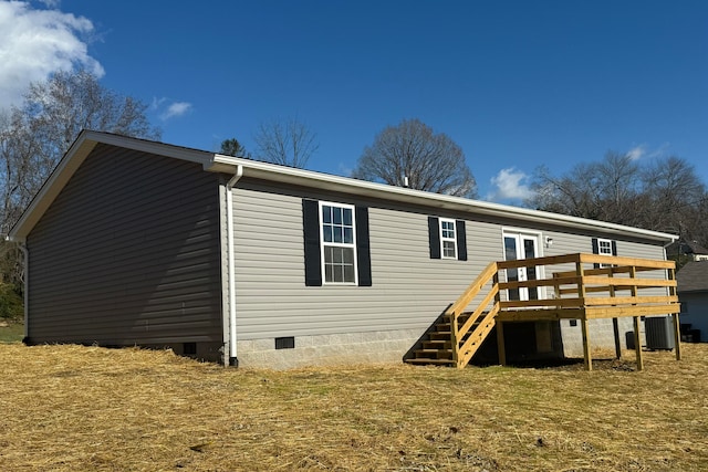 back of house with a yard, cooling unit, and a wooden deck