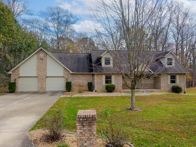 view of front of home with a front lawn and a garage